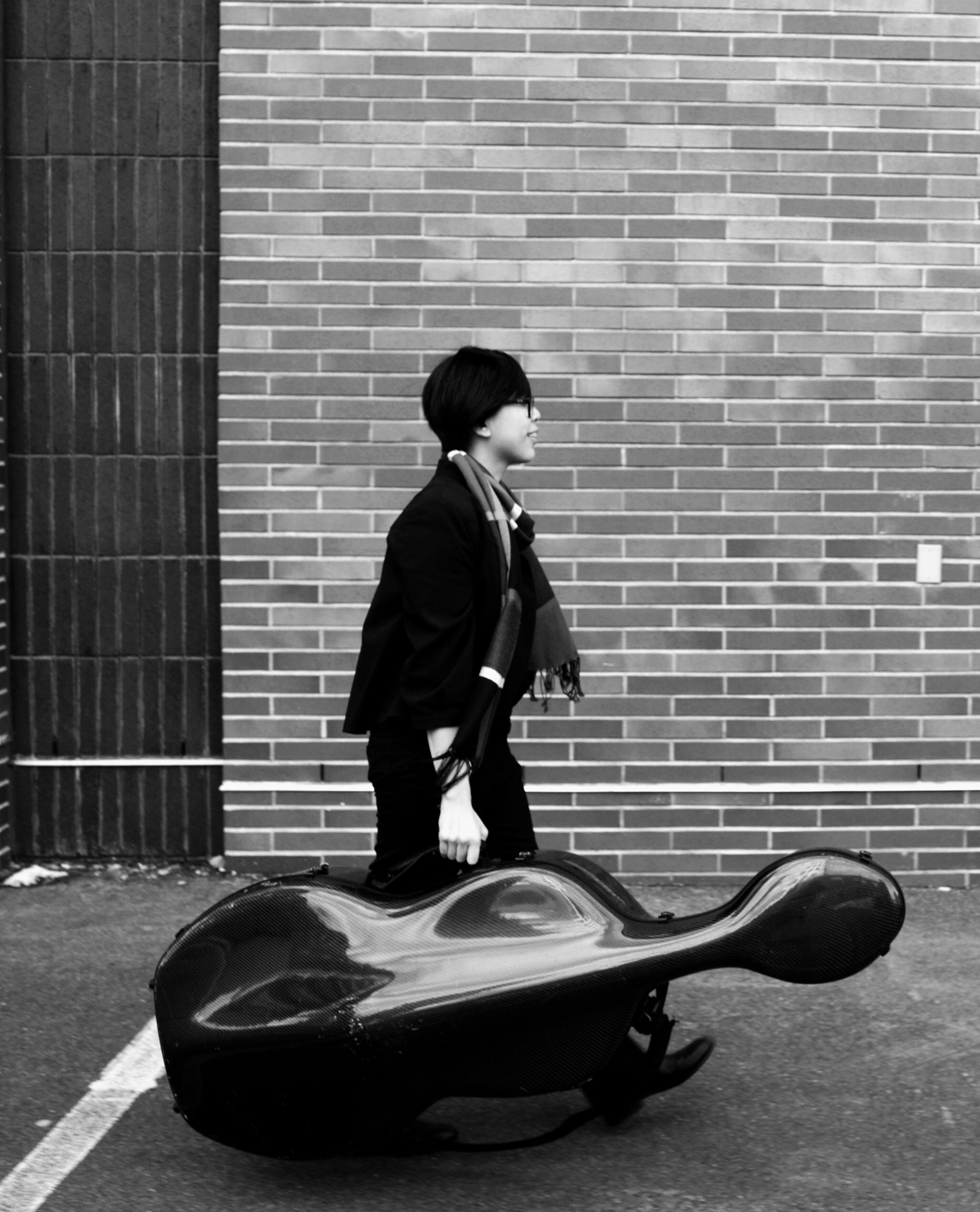 sara walking with cello in case